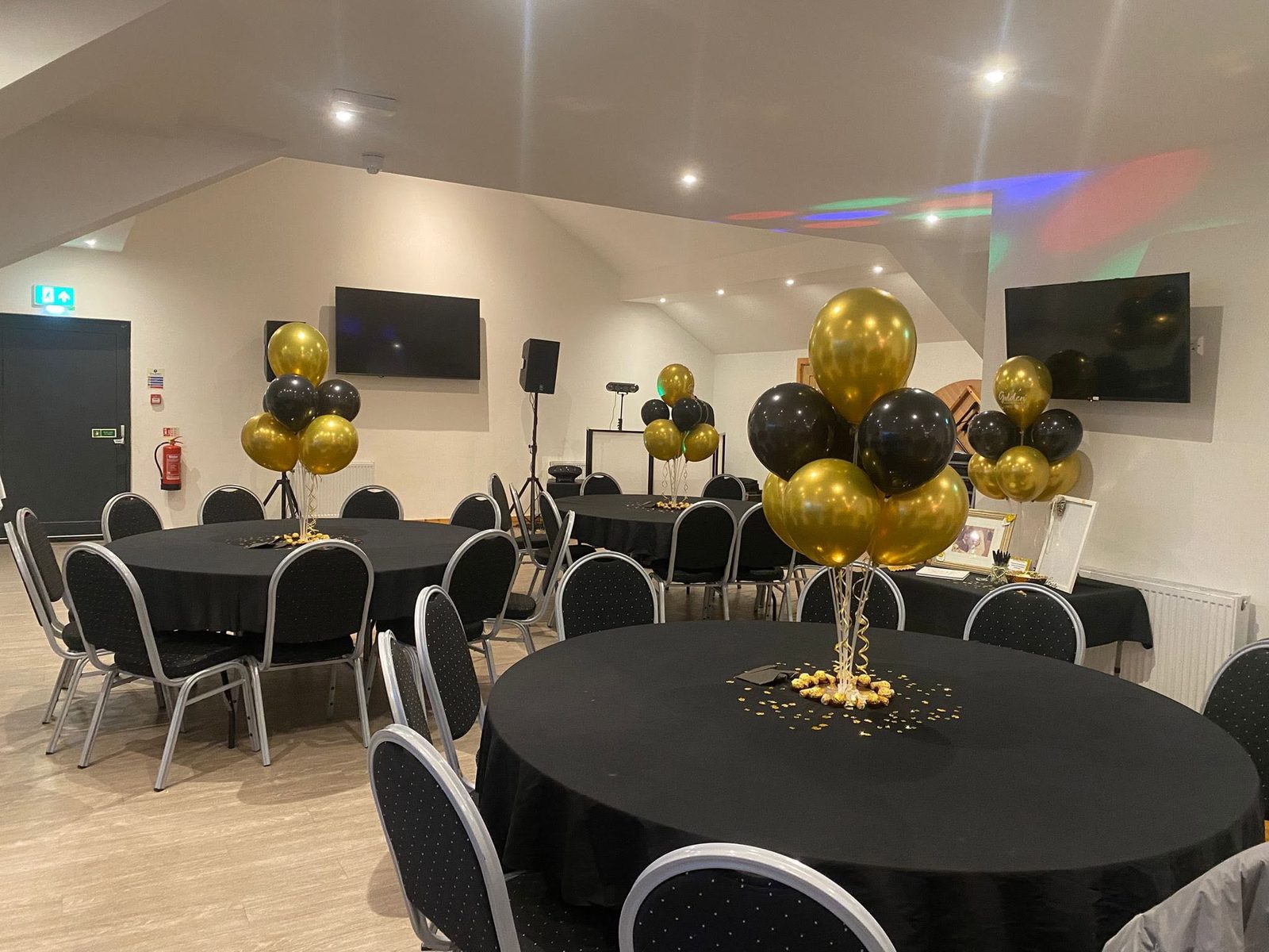 The Den clubhouse set up with round tables for an event
