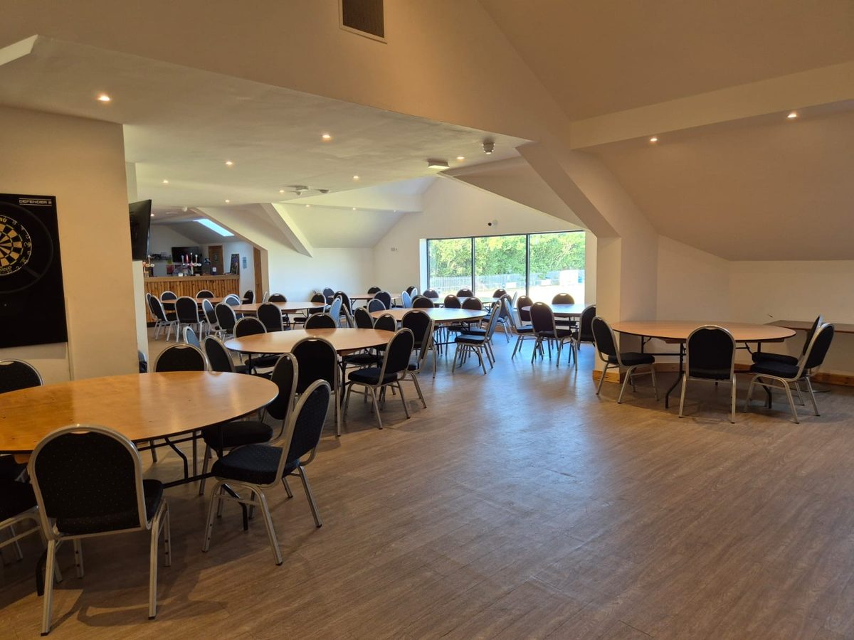 The function room laid out with round tables and chairs, ready for a meeting or conference