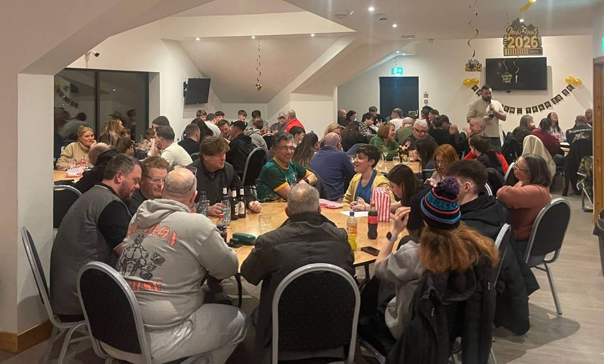 The function room in use for a large evening event, with decorations and a full crowd
